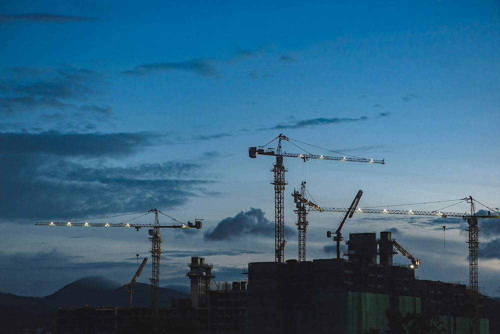 Construction cranes at dusk, representing rebuilding a website