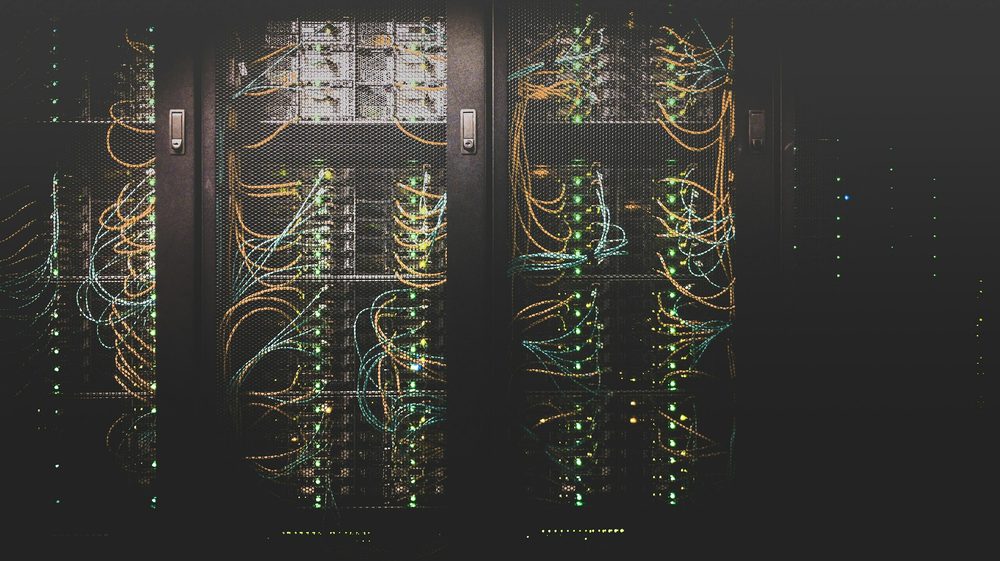 Server racks and cabling, the kind of infrastructure the security monitoring tool keeps watch over.
